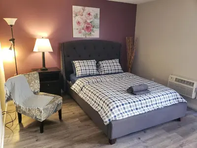 a small bedroom with a bed and a chair at Beverly Hills Suite with Balcony in Los Angeles