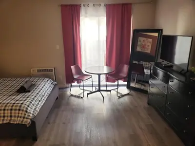 a bedroom with a bed and a table and chairs at Beverly Hills Suite with Balcony in Los Angeles