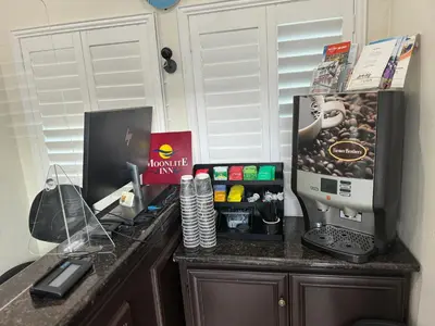 a desk with a computer on top of it at Moonlite Inn in Redondo Beach