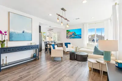 a living room with a couch and a table at Maison on the Beach in Los Angeles