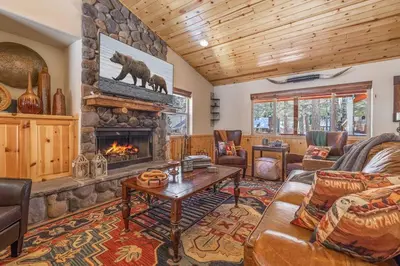 a living room with a couch and a fireplace at TimberWood Cabin- 3 Bdr - 2 Bth - Big Game room - Prime Location in Big Bear Lake in Big Bear Lake