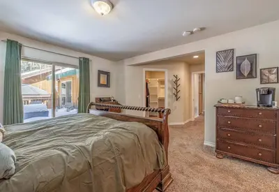 a bedroom with a bed and a dresser and a window at TimberWood Cabin- 3 Bdr - 2 Bth - Big Game room - Prime Location in Big Bear Lake in Big Bear Lake
