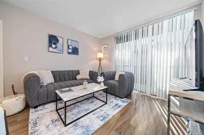 a living room with a couch and a table at Location Walk to the beach Chic Condo! in Los Angeles