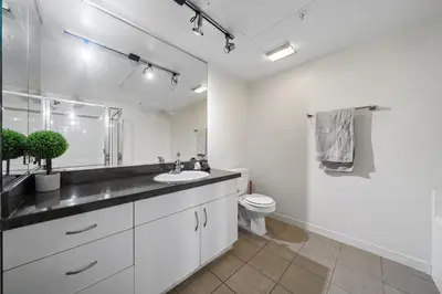 a white bathroom with a sink and a toilet at Location Walk to the beach Chic Condo! in Los Angeles