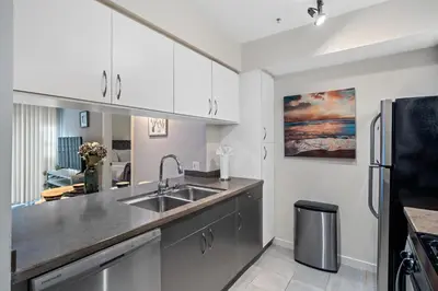 a kitchen with a sink and a refrigerator at Location Walk to the beach Chic Condo! in Los Angeles