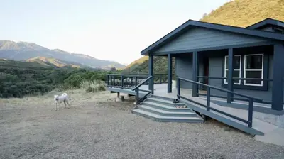 a blue house with a horse standing outside of it at Ojai Wilderness Off-The-Grid Sespe House in Ojai