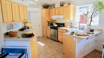a kitchen with wooden cabinets and a counter top at Ojai Wilderness Off-The-Grid Sespe House in Ojai