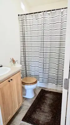 a bathroom with a toilet and a shower curtain at Ojai Wilderness Off-The-Grid Sespe House in Ojai