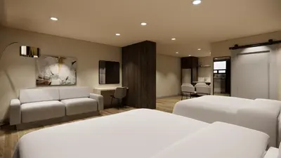 a hotel room with two beds and a couch at Kins Hotel in Los Angeles