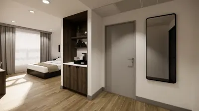 a bedroom with a bed and a mirror on the wall at Kins Hotel in Los Angeles