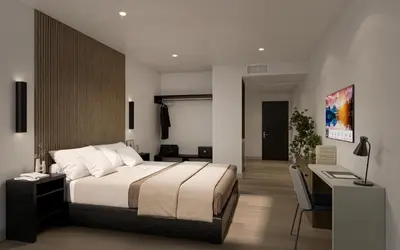 a bedroom with a large bed and a desk at Kins Hotel in Los Angeles
