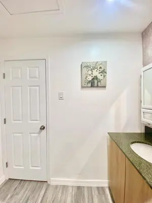 a bathroom with a white door and a sink at 1BR Pink Cozy House near DTLA in Rosemead