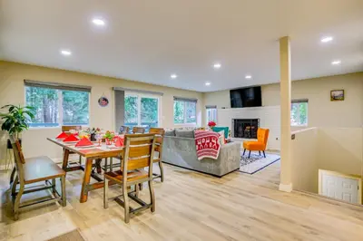 a dining room and living room with a table and chairs at 4 Mi to Lake Arrowhead Cabin with Grill and Deck! in Twin Peaks