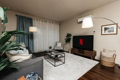a living room with a tv and a couch at Signature One Bedroom Apartment in Los Angeles