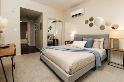 a bedroom with a bed and a living room at Signature One Bedroom Apartment in Los Angeles