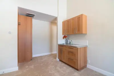 a kitchen with a sink and wooden cabinets at Beautiful 6BR Family 2-Story Villa With Large Backyard and Outdoor Kitchen in Los Angeles