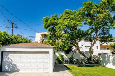 a white garage door in front of a house at Beautiful 6BR Family 2-Story Villa With Large Backyard and Outdoor Kitchen in Los Angeles