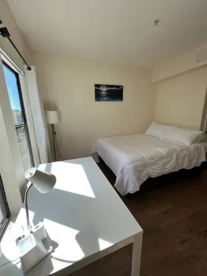 a room with two beds and a desk with a lamp at ELEGANT RESORT-SoCal-Lux on 3rd in Los Angeles