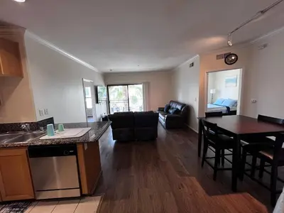 a kitchen and living room with a table and chairs at ELEGANT RESORT-SoCal-Lux on 3rd in Los Angeles