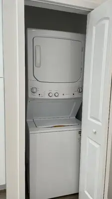 a microwave in a closet with a white door at Luxury mini house in Hughes-Canoga Park Heliport