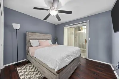 a bedroom with a bed with a ceiling fan at 3 Bed 2 Bath Newly Furnished - Available Now in Bakersfield