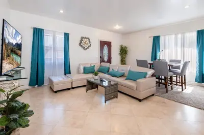 a living room with a couch and a table at Spacious 2BR Apartment with Full Kitchen & Dining In Beverly Hills in Los Angeles