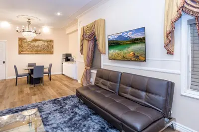 a living room with a couch and a table at Spacious 2BR with Kitchenette and Dining in Beverly Hills in Los Angeles