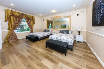 a bedroom with two beds and a mirror at Spacious 2BR with Kitchenette and Dining in Beverly Hills in Los Angeles