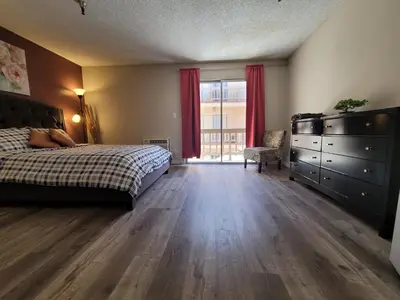 a bedroom with a bed and a dresser and a window at Beverly Hills Suite in Los Angeles