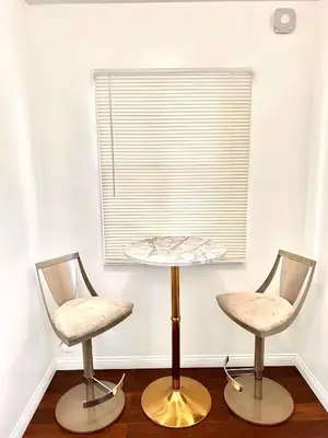 two chairs and a table in a room with a window at Los Angeles Red Rose in Monterey Park