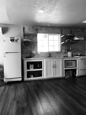 a kitchen with white cabinets and a white refrigerator at Noah Unit - B in Hawthorne