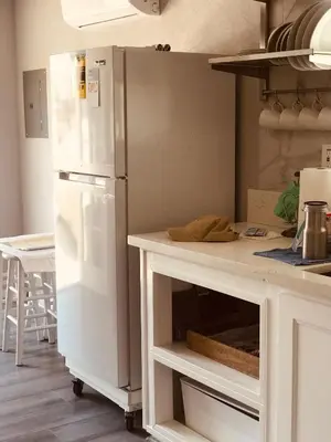 a kitchen with a white refrigerator and a counter at Noah Unit - B in Hawthorne