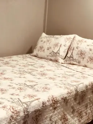 a bed with a white blanket and a pillow at Noah Unit - B in Hawthorne