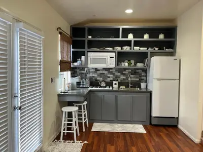a kitchen with a white refrigerator and a counter at Jacob Unit-C in Hawthorne