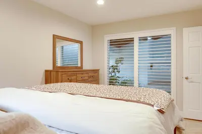 a bedroom with a bed and a mirror and a window at 2 Mi to Promenade at Westlake Mtn-View Haven! in Westlake Village