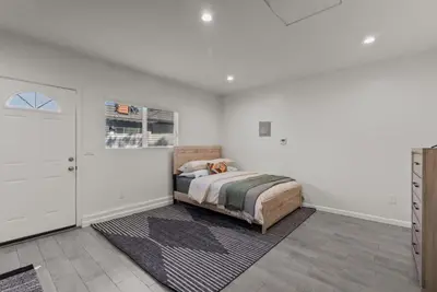 a bedroom with a bed in a white room at Charming Valley Village Studio Retreat in Los Angeles