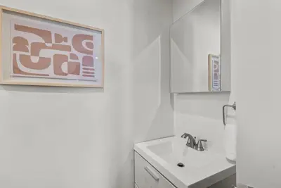 a white bathroom with a sink and a mirror at Charming Valley Village Studio Retreat in Los Angeles