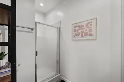 a sliding glass door in a white room with a picture at Charming Valley Village Studio Retreat in Los Angeles
