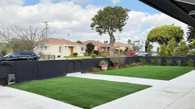 a garden with green grass and a black fence at Modern Studio Stylish &Cozy Right Unit in Los Angeles
