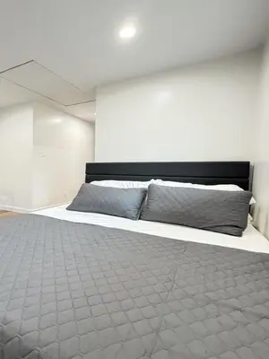 a bedroom with a bed with two pillows on it at Modern Studio Stylish &Cozy Ieft Unit in Los Angeles