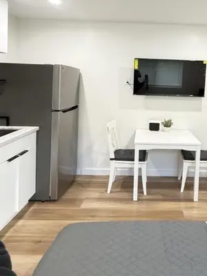 a kitchen with a white table and a refrigerator at Modern Studio Stylish &Cozy Ieft Unit in Los Angeles
