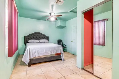 a bedroom with a bed and a ceiling fan at 8 Mi to Dtwn LA Apt with Shared Patio! in Los Angeles