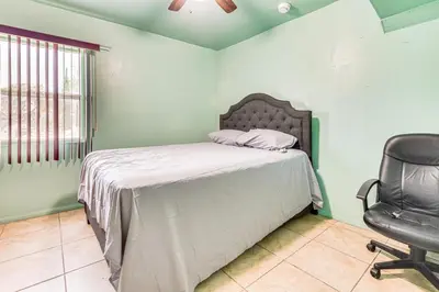 a bedroom with a bed and a chair at 8 Mi to Dtwn LA Apt with Shared Patio! in Los Angeles