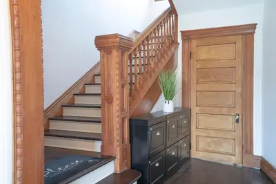 a staircase with a wooden stair case and a wooden door at Burlington Hostel in Los Angeles