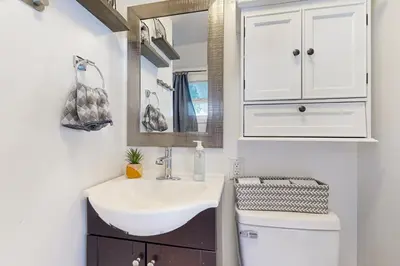 a bathroom with a sink and a toilet and a mirror at Relaxing Retreat with Deck, 1 Mi to Lake Arrowhead! in Cedar Glen