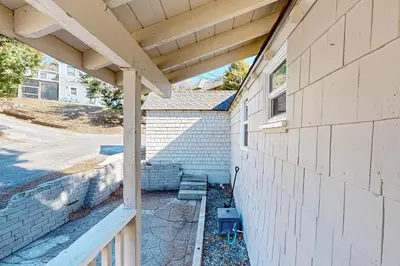 an outside view of a house with a roof at Relaxing Retreat with Deck, 1 Mi to Lake Arrowhead! in Cedar Glen