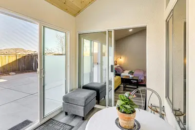 a living room with a table and a chair at 10 Mi to Mojave Narrows Victorville Studio in Victorville