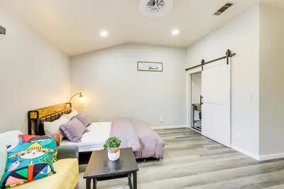 a living room with a bed and a couch at 10 Mi to Mojave Narrows Victorville Studio in Victorville