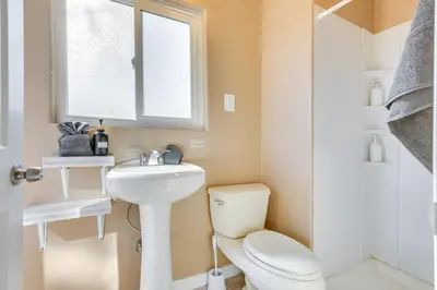 a bathroom with a toilet and a sink and a window at Lake and Mountain Views Cozy California Stay in Mountain Mesa