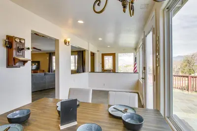 a dining room and living room with a wooden table at 6 Mi to Lake Isabella Mountain Mesa Getaway in Mountain Mesa